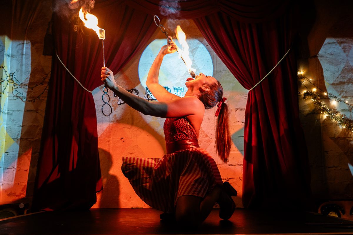 Circus fire performer on stage at Trapeze, Shoreditch, London